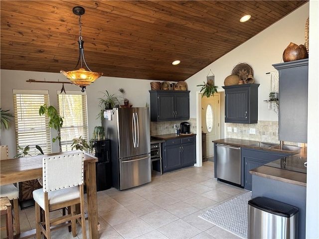 170 Paddle Boat Ln, Linn Valley, KS 66040 - kitchen with light tile patterned floors, lofted ceiling, wood ceiling, appliances with stainless steel finishes, and dark countertops