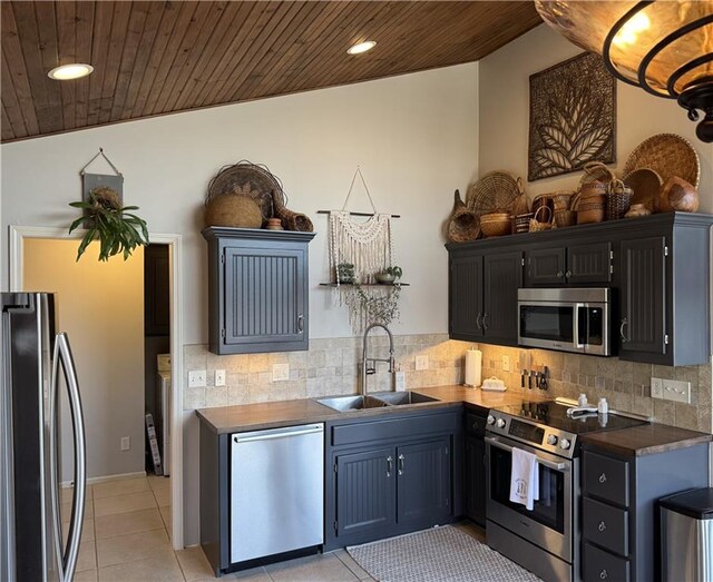 170 Paddle Boat Ln, Linn Valley, KS 66040 - kitchen featuring a sink, dark countertops, appliances with stainless steel finishes, wooden ceiling, and light tile patterned floors
