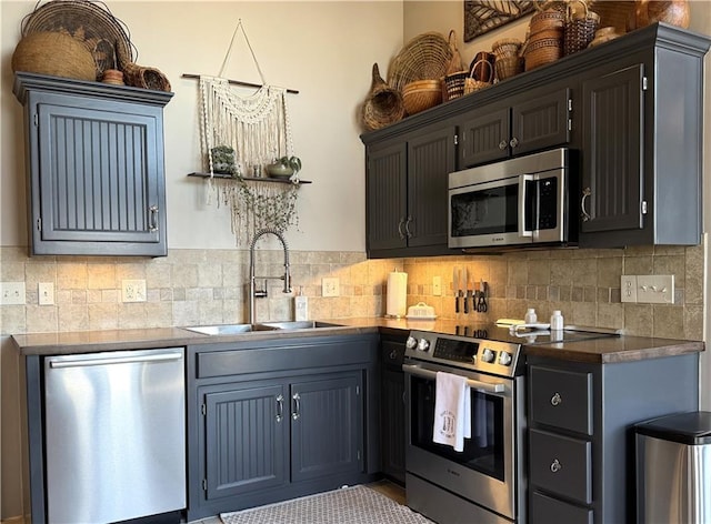 170 Paddle Boat Ln, Linn Valley, KS 66040 - kitchen featuring decorative backsplash, dark countertops, appliances with stainless steel finishes, and a sink