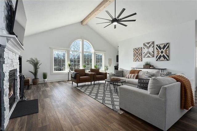 living room with beam ceiling, a fireplace, dark wood-type flooring, ceiling fan, and high vaulted ceiling