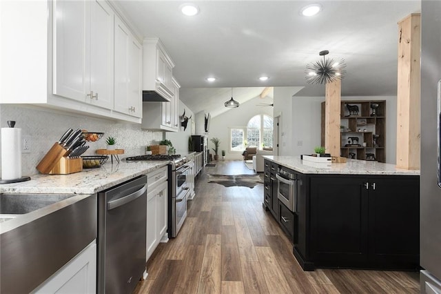 kitchen featuring white cabinets, a ceiling fan, lofted ceiling, dark cabinets, and stainless steel appliances