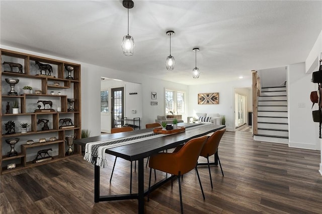 dining space featuring stairs and dark wood finished floors