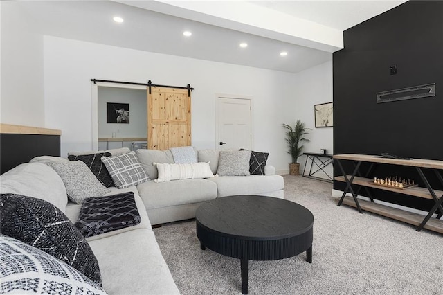 carpeted living area with recessed lighting, baseboards, and a barn door