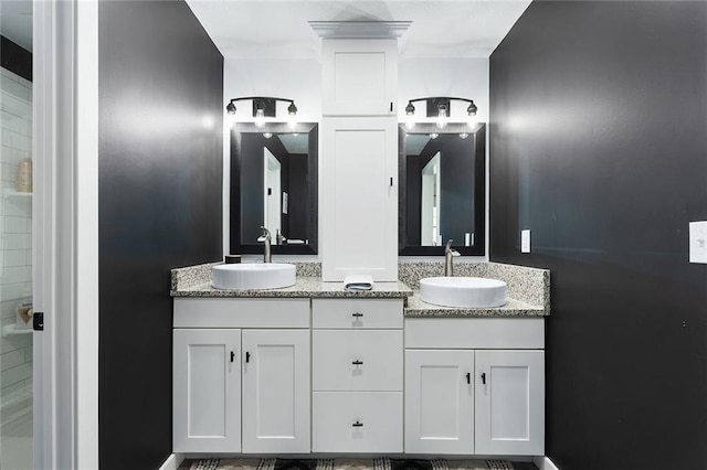 bathroom with a sink and double vanity