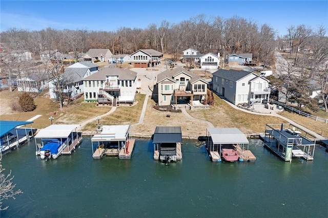 bird's eye view with a residential view and a water view