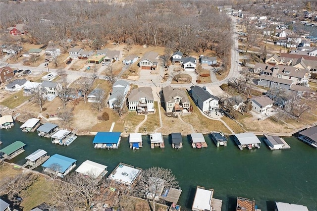 drone / aerial view featuring a residential view and a water view