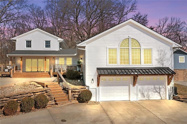 view of front facade with metal roof, a standing seam roof, and an attached garage