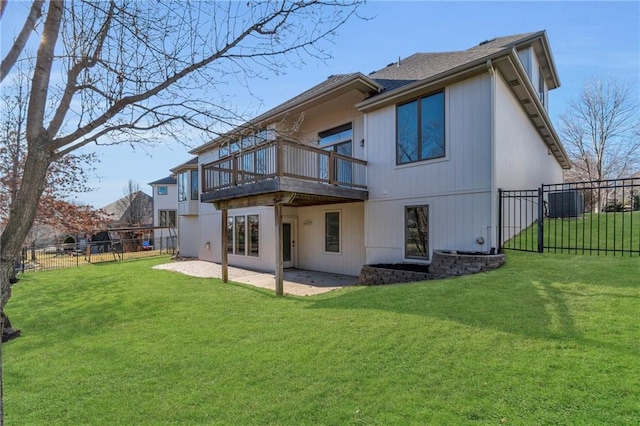 back of house featuring a lawn, a patio area, and a fenced backyard