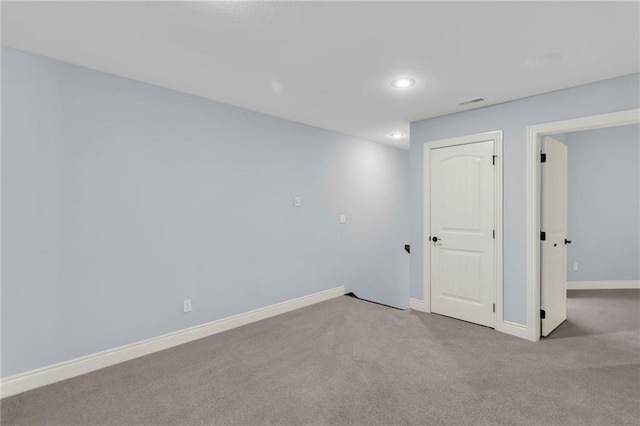 carpeted spare room with recessed lighting and baseboards