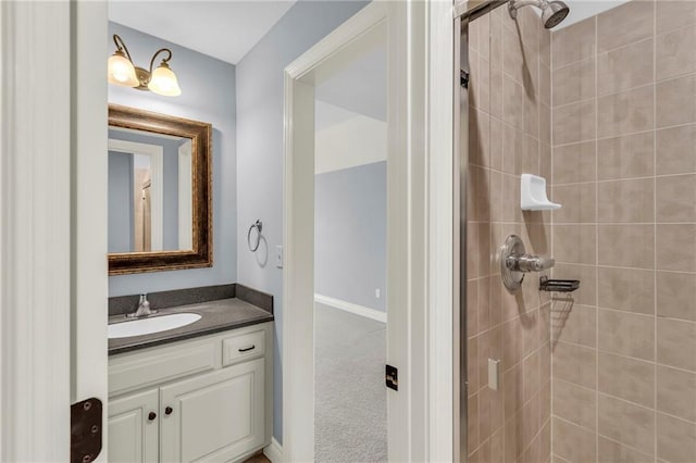 bathroom featuring a tile shower and vanity