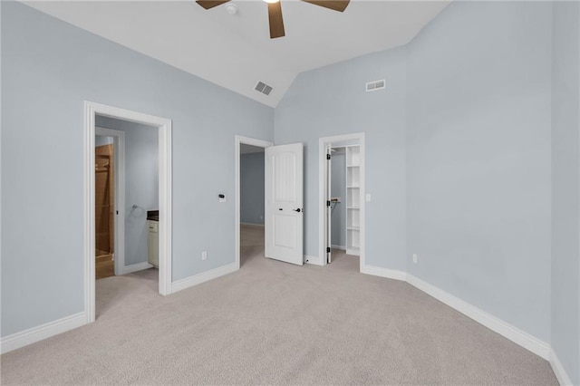 unfurnished bedroom featuring baseboards, a spacious closet, and visible vents