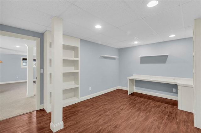 finished basement featuring built in features, baseboards, wood finished floors, and recessed lighting