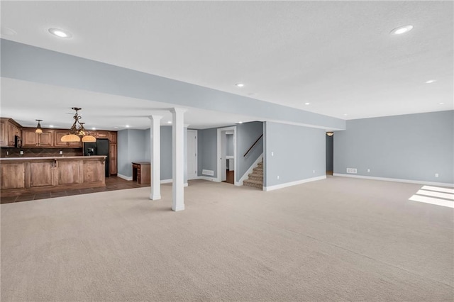 below grade area featuring recessed lighting, baseboards, stairway, and light colored carpet