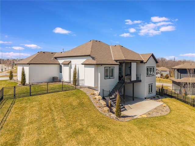 4510 NW 70th Ter, Kansas City, MO 64151 - rear view of property with stairs, cooling unit, a yard, a fenced backyard, and a patio area