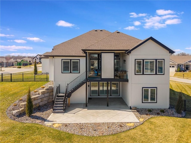 4510 NW 70th Ter, Kansas City, MO 64151 - back of house with a patio area, a lawn, a shingled roof, and fence