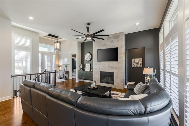 4510 NW 70th Ter, Kansas City, MO 64151 - living room with dark wood-style floors, a tile fireplace, and ceiling fan