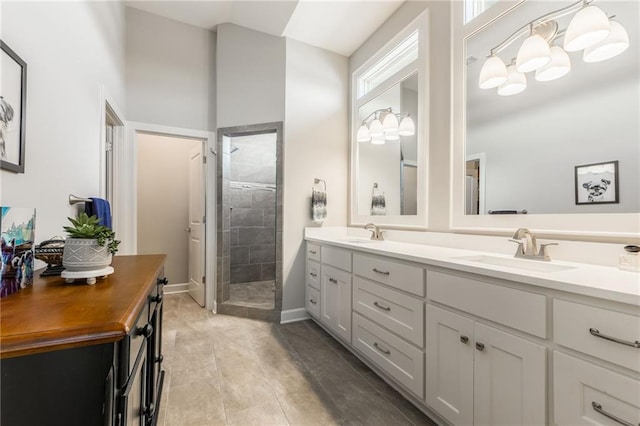 4510 NW 70th Ter, Kansas City, MO 64151 - full bathroom featuring a tile shower, double vanity, baseboards, and a sink