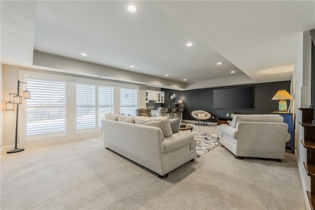 4510 NW 70th Ter, Kansas City, MO 64151 - carpeted living area featuring a raised ceiling, recessed lighting, and a textured ceiling