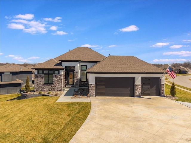 view of front of property with stone siding, an attached garage, concrete driveway, and a front yard