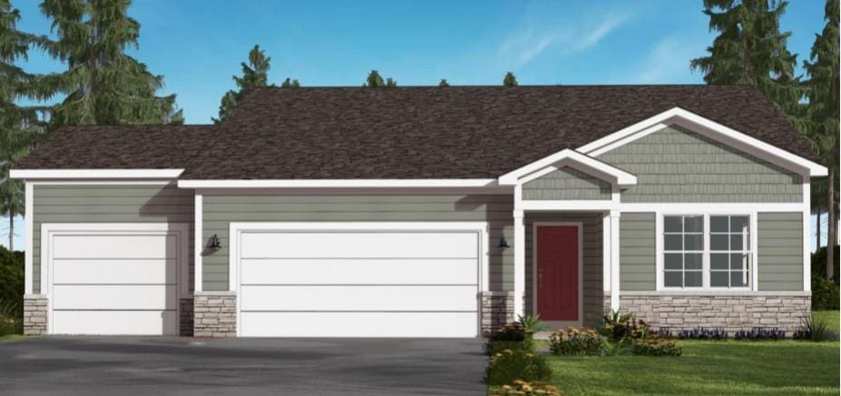 view of front of property with an attached garage, stone siding, and driveway