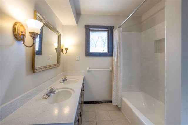 full bath featuring baseboards, shower / bath combination with curtain, a sink, and tile patterned floors