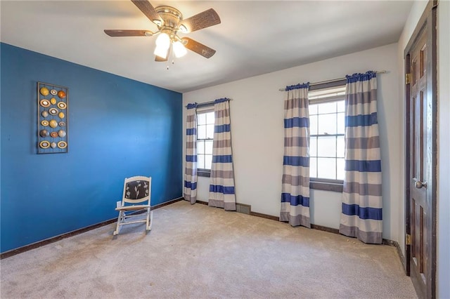 miscellaneous room with a healthy amount of sunlight, ceiling fan, baseboards, and carpet flooring