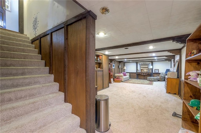 stairs featuring carpet flooring and beamed ceiling