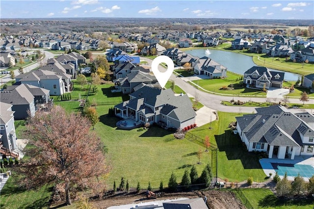 birds eye view of property with a water view and a residential view