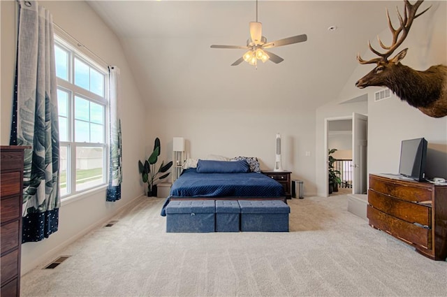 carpeted bedroom with lofted ceiling, visible vents, and multiple windows