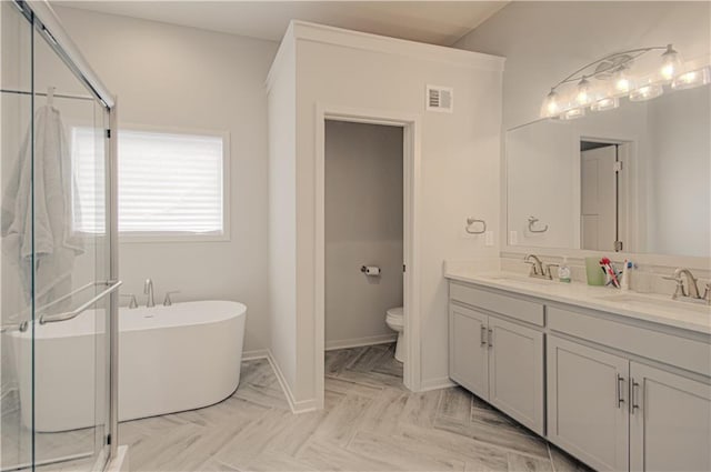 full bathroom with double vanity, a stall shower, visible vents, toilet, and a sink