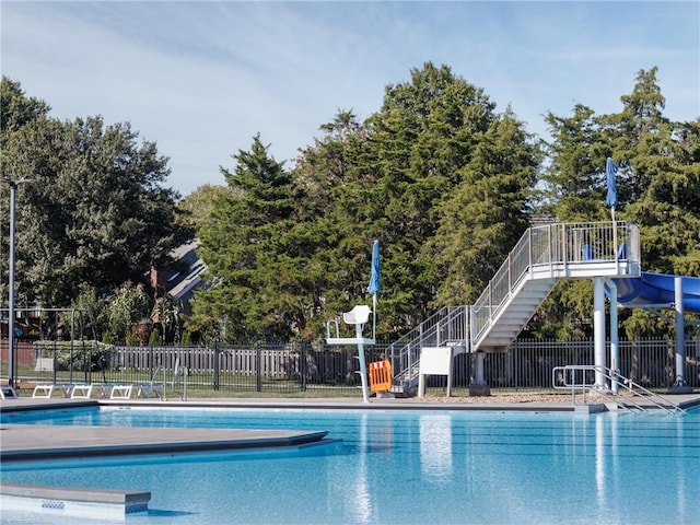 community pool with stairway and fence