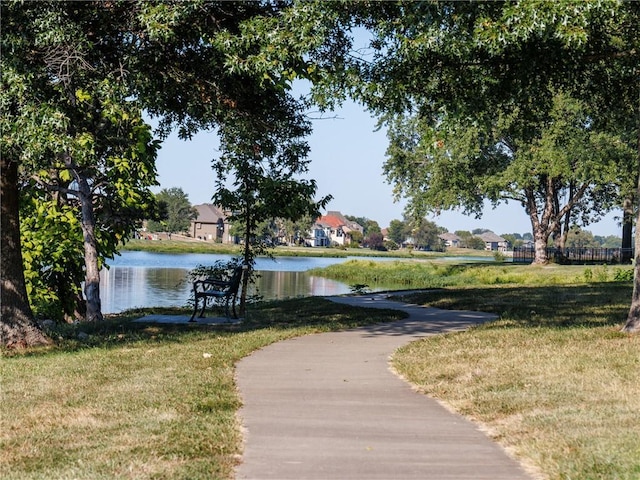 view of community featuring a water view and a lawn