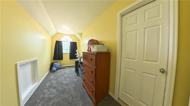 interior space with carpet floors, vaulted ceiling, and baseboards