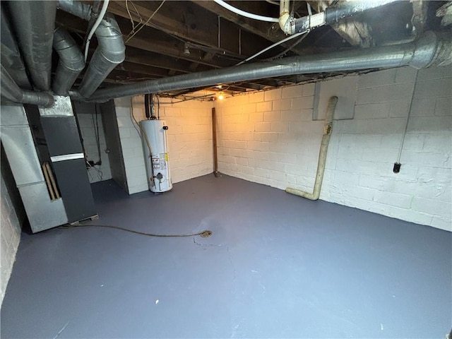 unfinished basement with gas water heater, concrete block wall, and heating unit