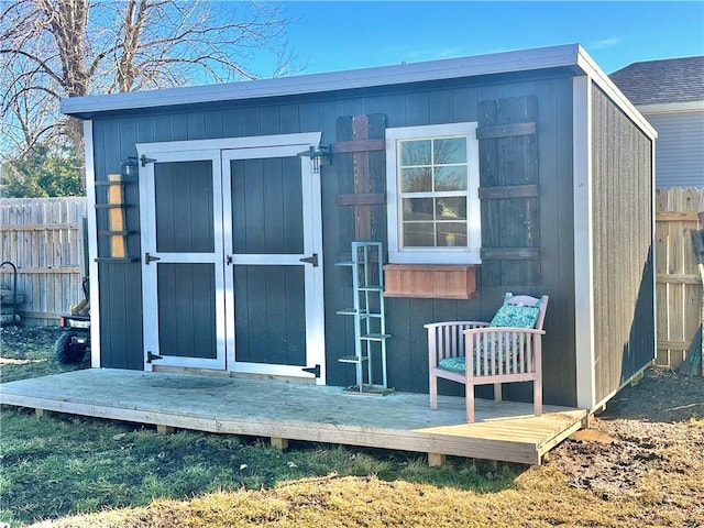 view of shed with fence