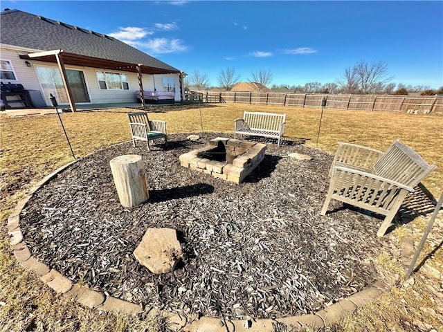 view of yard featuring an outdoor fire pit, fence, and a patio