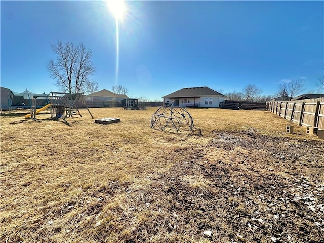 view of yard featuring a fenced backyard and a playground