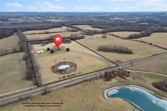 birds eye view of property with a rural view