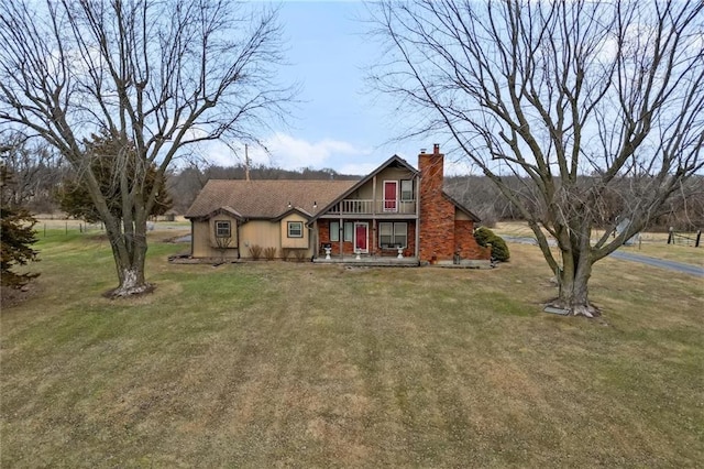 view of front of home with a chimney and a front lawn