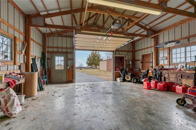 garage with metal wall and a garage door opener