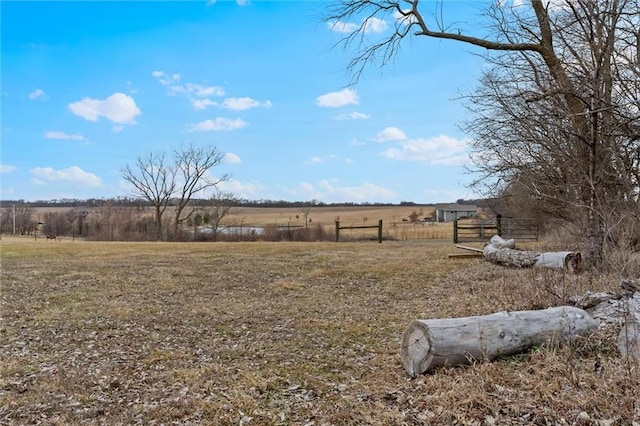 view of yard with a rural view and fence