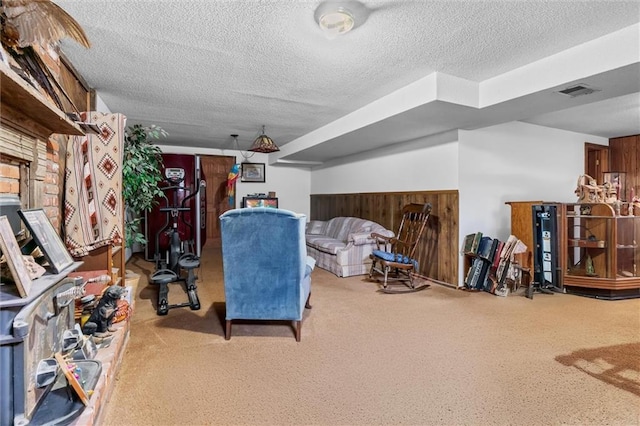 interior space with a textured ceiling, carpet floors, and visible vents