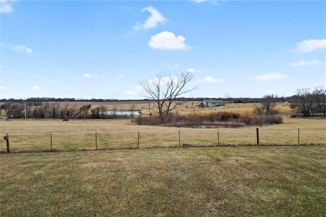 view of yard featuring a rural view and fence