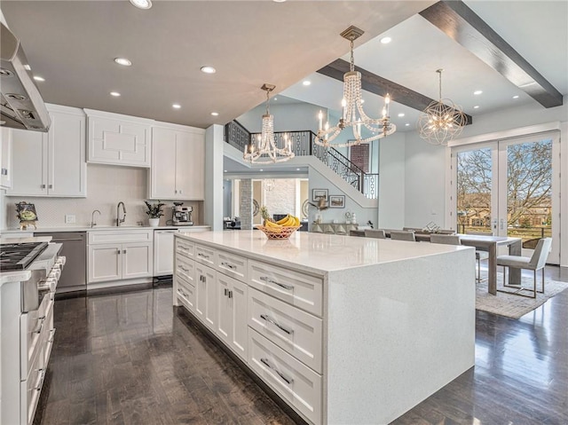 kitchen with dark wood-style floors, range hood, beam ceiling, backsplash, and white cabinetry