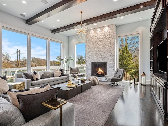 living room with dark wood-style floors, beam ceiling, a notable chandelier, a fireplace, and recessed lighting