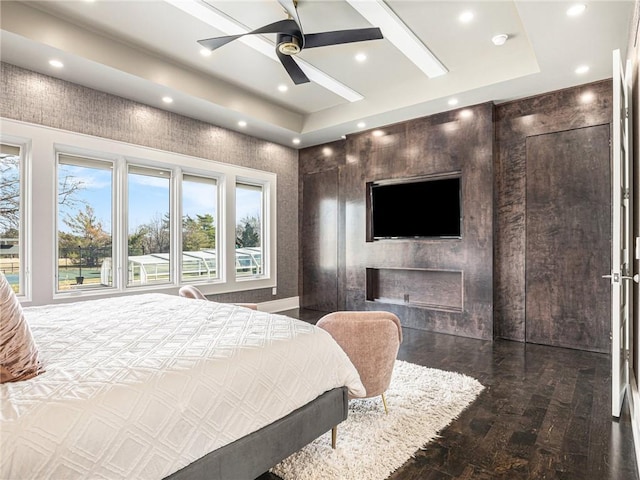 bedroom featuring ceiling fan, a raised ceiling, wood finished floors, and recessed lighting