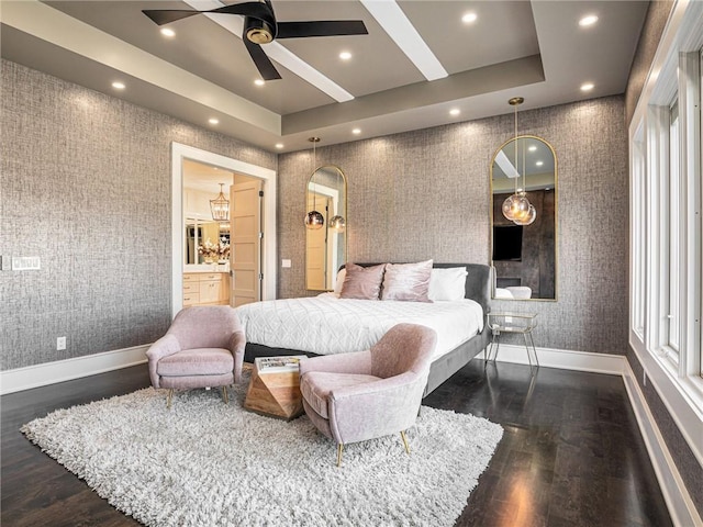 bedroom featuring a tray ceiling, dark wood-style flooring, recessed lighting, baseboards, and wallpapered walls