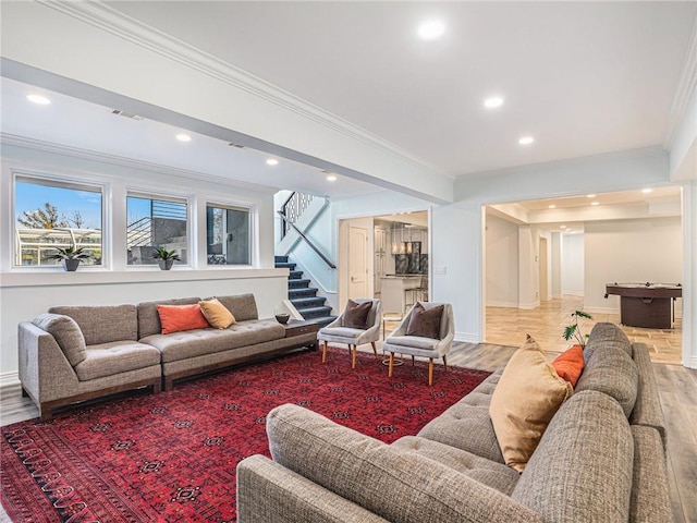 living room featuring light wood-type flooring, recessed lighting, stairway, and ornamental molding