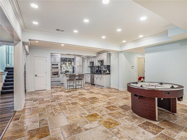 game room featuring stone tile floors, recessed lighting, visible vents, ornamental molding, and baseboards