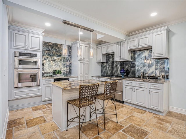 kitchen featuring tasteful backsplash, light stone counters, crown molding, stone tile flooring, and double oven